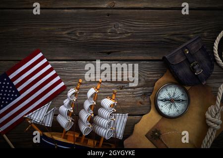 Columbus Day. Vintage discovery equipment with copy space on dark wooden background. Stock Photo