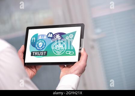 Trust concept shown on a tablet held by a man Stock Photo