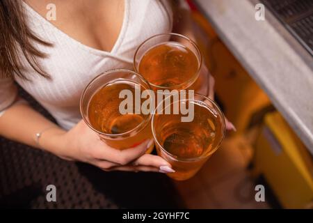 Closeup of Three Glasses of Beer Being Clinked Stock Photo