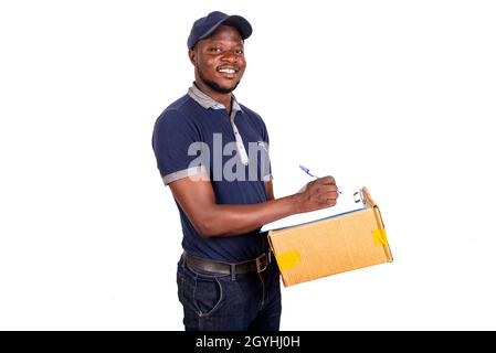 portrait of a handsome young delivery man writing on paper press smiling Stock Photo