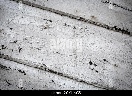 The old painted white cracked wooden surface. Selective focus Stock Photo