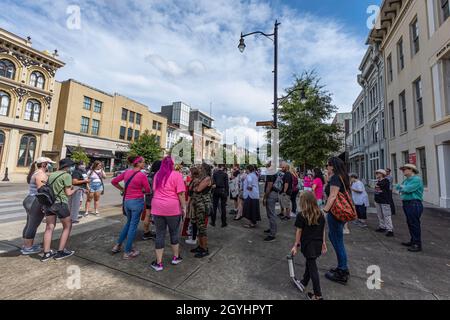 Montgomery, Alabama, USA - Oct. 2, 2021: Crowd of people gathers on Dexter Avenue near the fountain for the 2021 Women's March in downtown Montgomery. Stock Photo