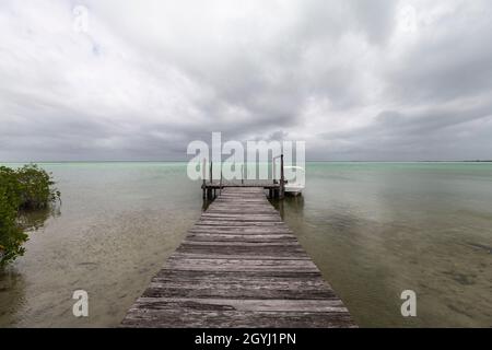 Small fishing boat dock with storm clouds on the Gulf of Mexico. Stock Photo