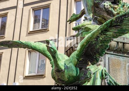 Goose with spread wings as part of the bronze statue of the Goose Thief Fountain (Gänsediebbrunnen) by Robert Diez, in Dresden, Saxony, Germany. Stock Photo