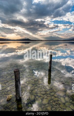 A relaxing, peaceful view at sunset of the Lake of Viverone, one of the many glacial lakes lying in the plain at the feet of the Alps. Stock Photo