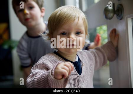 Young sibling children playing inside Stock Photo