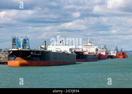 large oil tanker ships alongside at the exxon mobil esso fawley oil refinery petrochemical processing plant at the port of southampton docks uk Stock Photo