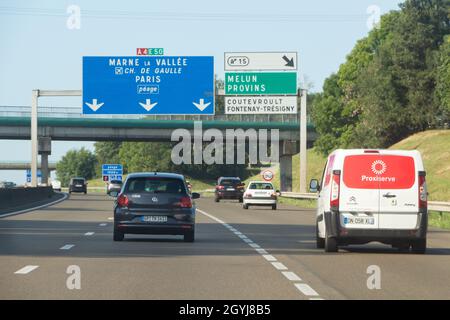 Melun – France, August 19, 2019 : Cars on the highway with roadsigns to Melun or Marne la Vallée Stock Photo