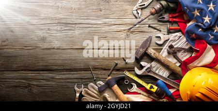 Labor Day - National Holiday - Construction Tools And Usa Flag On Wood Background Stock Photo