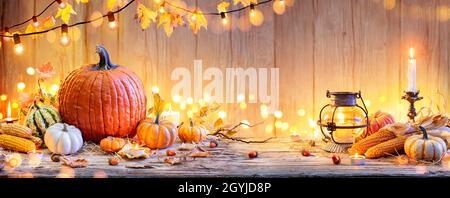Pumpkins On Wooden Table - Thanksgiving Background With Vegetables And Bokeh Lights Stock Photo