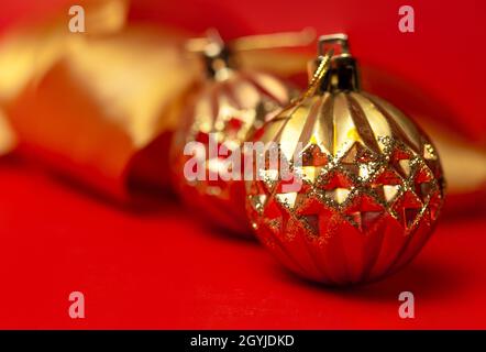 golden round Christmas toys on a red background Stock Photo