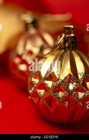 golden round christmas toys close-up on a red background Stock Photo