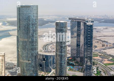 Aerial drone shot of Al Reem island buildings - Gate towers, Sun and Sky towers - Abu Dhabi city landmarks and attractions Stock Photo