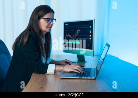 Business trader woman working on crypto currency markets with blockchain technology - Decentralized finance and stock exchange concept Stock Photo