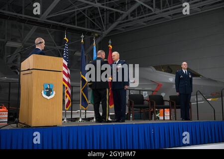 Army Brig. Gen. Greg Knight, the adjutant general of the Vermont National Guard, congratulates and shakes hands with Col. David Smith, outgoing commander of the 158th Fighter Wing, Vermont Air National Guard, during a change of command ceremony for the 158th Fighter Wing, Vermont Air National Guard Base, South Burlington, Vt., Jan. 5, 2020. Col. David Shevchik Jr. takes command of the wing from Smith who is retiring after more than 30 years in the Vermont Air National Guard. (U.S. Air National Guard photo by Miss Julie M. Shea) Stock Photo