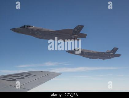 A pair of F-35 Lightning IIs, assigned to Hill Air Force Bases 388th Fighter Wing and 419th Fighter Wing, flies beside a KC-135R Stratotanker, assigned to the Utah Air National Guard’s 151st Air Refueling Wing during an exercise on January 6, 2020. The exercise generated 50 F-35s from Hill AFB, 24 of which were refueled by two Utah KC-135s during air refueling operations. (U.S. Air National Guard photo by Tech. Sgt. John Winn) Stock Photo