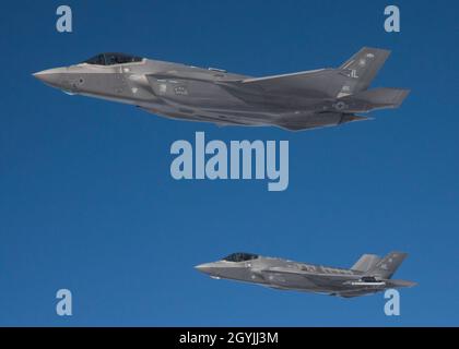 A pair of F-35 Lightning IIs, assigned to Hill Air Force Bases 388th Fighter Wing and 419th Fighter Wing, flies beside a KC-135R Stratotanker, assigned to the Utah Air National Guard’s 151st Air Refueling Wing during an exercise on January 6, 2020. The exercise generated 50 F-35s from Hill AFB, 24 of which were refueled by two Utah KC-135s during air refueling operations. (U.S. Air National Guard photo by Tech. Sgt. John Winn) Stock Photo