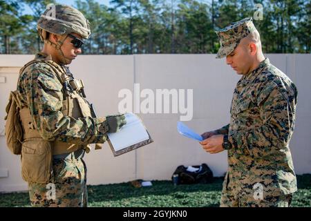 U.S. Marine Corps Cpl. Ruben Huerta, left, a transmission system operator with 2nd Assault Amphibian Battalion, 2nd Marine Division, is briefed by 1st Lt. Patrick Galindo, right, a logistics officer with 2nd AA Bn, to participate in the new Leadership Reaction Course (LRC) on Marine Corps Base Camp Lejeune, North Carolina, Jan. 7, 2020. More than 60 Marines with 2nd AAV maneuvered through four different obstacles, each requiring critical thinking and problem solving skills to maneuver. (U.S. Marine Corps photo by Cpl. Karina Lopezmata) Stock Photo