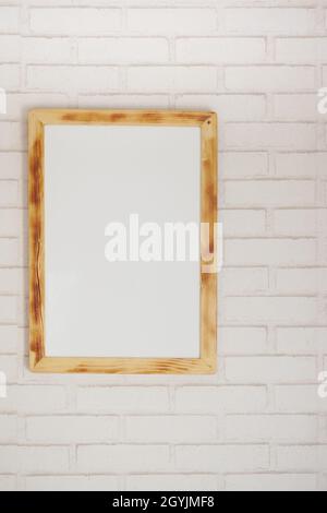 Black frame mockup on table against white wall, Stock Photo