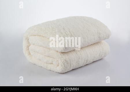 Soft and warm of white folded blanket isolated on white background Stock Photo