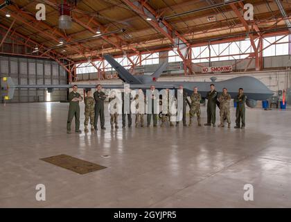 Some of the team who were directly involved the MQ-9 Reaper ferrying mission posed with the aircraft, Jan. 9, 2020, on Holloman Air Force Base, N.M. Airmen from the communications squadron, aircraft maintenance unit, and the 29th Attack Squadron were some of the members who ensured the success of ferrying an MQ-9 from California to Holloman. (U.S. Air Force photo by Airman 1st Class Autumn Vogt) Stock Photo