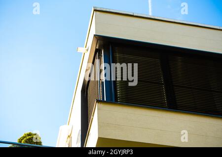 House with flat roof in the sunshine, blue sky Stock Photo