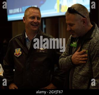 U.S. Air Force Col. Brian Laidlaw, 325th Fighter Wing commander, laughs with a local community member at the Bay County Chamber of Commerce monthly meeting at Panama City, Florida, Jan. 10, 2020. Laidlaw, along with Col. Travis Leighton, Tyndall Program Management Office director, and Cmdr. Kevin Christenson, Naval Support Activity Panama City commanding officer, attended the First Friday meeting as representatives of military communities in the local area. (U.S. photo by Staff Sgt. Magen M. Reeves) Stock Photo