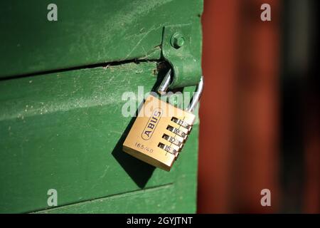 An open combination padlock on a shed door. Stock Photo