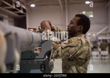 A load crew member from the 311th Fighter Squadron prepares an inert bomb for an F-16 Viper, Jan. 10, 2020, on Holloman Air Force Base, N.M. 12 Airmen from the 9th Aircraft Maintenance Unit, 29th AMU, 314th FS and 311th FS competed to see who could load munitions onto their respective aircraft the fastest. (U.S. Air Force photo by Airman 1st Class Quion Lowe) Stock Photo