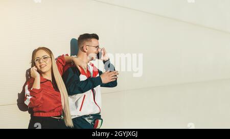 Young man and woman talking on their mobile phones Stock Photo