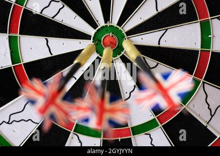Three steel tip darts in a dart board. Stock Photo