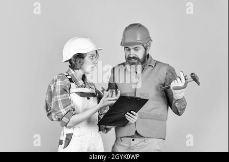 confident electrical and technician. engineers couple working together on building blueprint. work at construction site or factory. Civil engineering Stock Photo