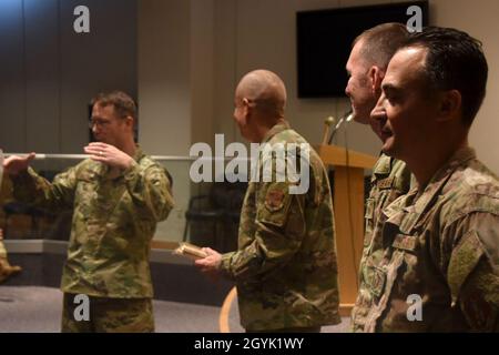 U.S. Air Force North Carolina Assistant Adjutant General for Air, Brig. Gen. Stephen Mallette (far left), and State Command Chief Master Sgt. David Rodriguez (left), commend Master Sgt. Daniel Judd (right) and Master Sgt. Kernice Locklear (far right), 263rd Combat Communications Squadron with awards during an all-call held at the New London, N.C. Air National Guard Base (NCANG) headquarters, Jan. 12, 2020. Members of the NCANG celebrated the accomplishments of Master Sgts. Judd and Locklear who attended the United States Marine Corps Staff Non-Commissioned Officer Academy last year in an effor Stock Photo