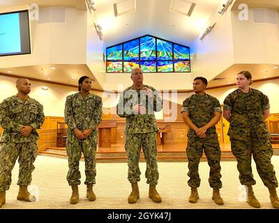 MARINE CORPS BASE HAWAII, Hawaii (Jan 13, 2020) US Navy Surgeon General, Rear Adm Bruce Gillingham, presents his coin to high performing Sailors assigned to 3rd Marine Regiment and Navy Medical Training and Readiness Command (NMRTC) Pearl Harbor at the base chapel on Marine Corps Base Hawai’i January 13, 2020. Rear Adm Gillingham is visiting operational and readiness Navy medical units in the Pacific to talk about ensuring readiness by providing well trained people, working in cohesive teams on optimized platforms, demonstrating high velocity performance to project medical power in support of Stock Photo