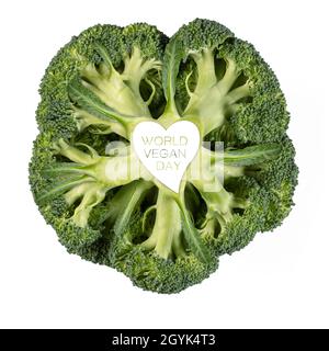 World Vegan Day design with a fresh head of broccoli with heart sign and text on the stem in a healthy plant based diet and super food concept isolate Stock Photo