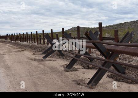 Outdated Normandy-style vehicle barriers along the U.S.-Mexico border will be replaced with a steel bollard barrier system near Douglas, Arizona, January 15, 2020. The U.S. Army Corps of Engineers, South Pacific Border District is providing contracting services, including design and construction oversight, of Department of Defense-funded Southwest border barrier projects in California, Arizona, New Mexico and Texas at the direction of the Administration and at the request of Department of Homeland Security, Customs and Border Protection (no one in this photo crossed the international border). Stock Photo