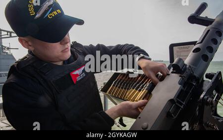 NORFOLK (Jan. 16, 2020) Aviation Ordnanceman Airman Luis Gonzalez, from Anchorage, Alaska, assigned to USS Gerald R. Ford's (CVN 78) weapons department, loads ammunition into an M240B .50 caliber machine gun on the ship's fantail as the ship gets underway. Ford is currently underway conducting aircraft compatibility testing. (U.S. Navy photo by Mass Communication Specialist Seaman Zack Guth) Stock Photo