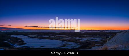 The still close pairing of Jupiter and Saturn in the evening twilight over the Bow River Valley, in southern Alberta, taken from the Siksika First Nat Stock Photo