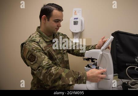 U.S. Air Force Senior Airman Alexander Peterson, 633rd Aerospace Medical Squadron ophthalmic technician, measures a patient’s prescription eyeglasses using a lensometer at Joint Base Langley-Eustis, Virginia, Jan. 27, 2020. The lensometer tells where the light is coming in. (U.S. Air Force photo by Airman 1st Class Sarah Dowe) Stock Photo