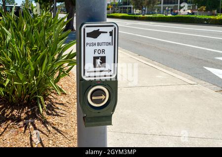 Fullerton, CA, USA – August 1, 2021: Crosswalk push button device on a street pole on Commonwealth Ave in Fullerton, California. Stock Photo
