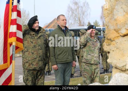 Commander of the Polish Armed Forces, Gen. Jaroslaw Mika (Left), Polish Ambassador to NATO, Ambassador Tomasz Szatkowski (Middle) and Commanding General of U.S. Army Europe, Lt. Gen. Christopher Cavoli (Right) salute the Polish monument at The Polish Rededication Ceremony at Hohenfels training area, Germany, Jan. 27, 2020. The renovated Polish monument serves to perpetuate the memory of the Polish displaced people who lived at Hohenfels after World War II. (U.S. Army photo by Spc. Audrequez Evans, JMRC Public Affairs) Stock Photo