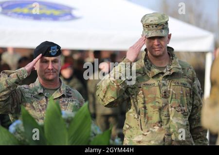 Commanding General of U.S. Army Europe, Lt. Gen. Christopher Cavoli (Right) and Deputy Commanding General, Maj. Gen. Joseph Jarrard salute the Polish monument at The Polish Rededication Ceremony at Hohenfels training area, Germany, Jan. 27, 2020. The renovated Polish monument serves to perpetuate the memory of the Polish displaced people who lived at Hohenfels after World War II. (U.S. Army photo by, Spc. Audrequez Evans JMRC Public Affairs) Stock Photo