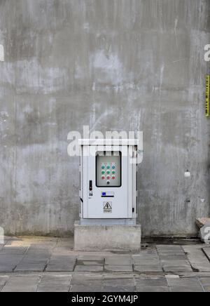 electrical control box, large wall mounted box ion a concrete wall and ceiling in modern building, loft design or concept. Stock Photo