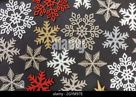 Winter season holidays, Christmas and New year concept. Shiny snowflakes flat lay on black background, Stock Photo