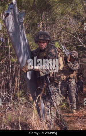 200129-M-YD783-0075 CAMP LEJEUNE (January 29, 2020) – U.S. Marine Private First Class Emmanuel Cogniaux an infantry rifle Marine with 3rd Battalion, 2nd Marine Regiment, 22nd Marine Expeditionary Unit, carries a piece of an Unmanned Aircraft System during tactical recovery of air-craft and personnel training at the expeditionary operations training group at Stone Bay aboard Camp Lejeune, N.C., January 29, 2020. Marines with 3rd Battalion, 2nd Marine Regiment are conducting training in preparation for an upcoming deployment (U.S. Marine Corps photo by Cpl. Tawanya Norwood/Released) Stock Photo