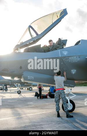 A pilot from the 63rd Fighter Squadron shakes hands with an F-35 ...