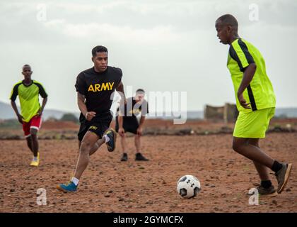 1st Lt. Rolando Fernandez, platoon leader, 1st Battalion, 200th Infantry Regiment (1-200 In), Alpha Company, New Mexico Army National Guard, assigned to Combined Joint Task Force – Horn of Africa (CJTF-HOA), defends a Djiboutian Army Rapid Intervention Battalion (RIB) soldier during a soccer match near Djibouti City, Djibouti, Jan. 30, 2020. Events such as the soccer match strengthen relationships and build esprit de corps between CJTF-HOA service members and RIB soldiers. (U.S. Air Force photo by Senior Airman Dylan Murakami)