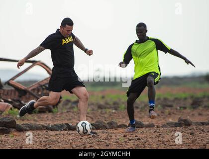 Staff Sgt. Christopher Nevarez, squad leader, 1st Battalion, 200th Infantry Regiment (1-200 In), Alpha Company, New Mexico Army National Guard, assigned to Combined Joint Task Force – Horn of Africa (CJTF-HOA), kicks a soccer ball down the field during a match against Djiboutian Army Rapid Intervention Battalion (RIB) soldiers near Djibouti City, Djibouti, Jan. 30, 2020. The RIB soldiers won the match six points to three. (U.S. Air Force photo by Senior Airman Dylan Murakami)