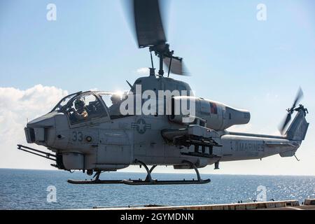 200131-N-GR168-1155 ARABIAN SEA (Jan. 31, 2020) An AH-1W Super Cobra helicopter, attached to the Blue Knights Marine Medium Tiltrotor Squadron (VMM) 365 (Reinforced), takes off from the flight deck of the amphibious transport dock ship USS New York (LPD 21). New York, with the Bataan Amphibious Ready Group and with embarked 26th Marine Expeditionary Unit, is deployed to the U.S. 5th Fleet area of operations in support of naval operations to ensure maritime stability and security in the Central Region, connecting the Mediterranean and the Pacific through the western Indian Ocean and three strat Stock Photo