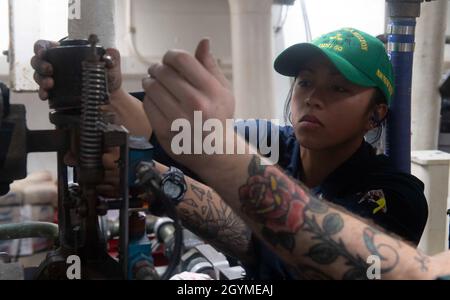 PACIFIC OCEAN (Feb. 1, 2020) U.S. Navy Machinist’s Mate 1st Class Wendy Lai, from Earlimart, Calif., removes a valve cap aboard the Arleigh Burke-class guided-missile destroyer USS Paul Hamilton (DDG 60) Feb. 1, 2020. Paul Hamilton, part of the Theodore Roosevelt Carrier Strike Group, is on a scheduled deployment to the Indo-Pacific. (U.S. Navy photo by Mass Communication Specialist 3rd Class Matthew F. Jackson)